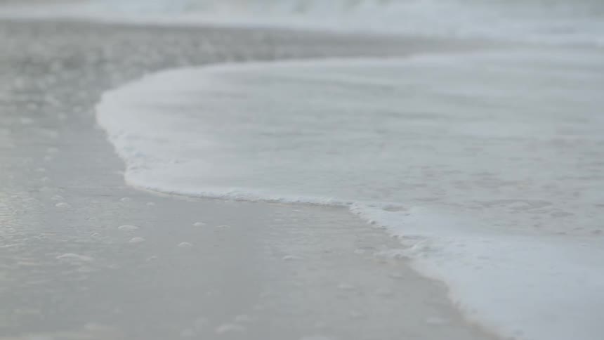 Water creeps on the sand ahead