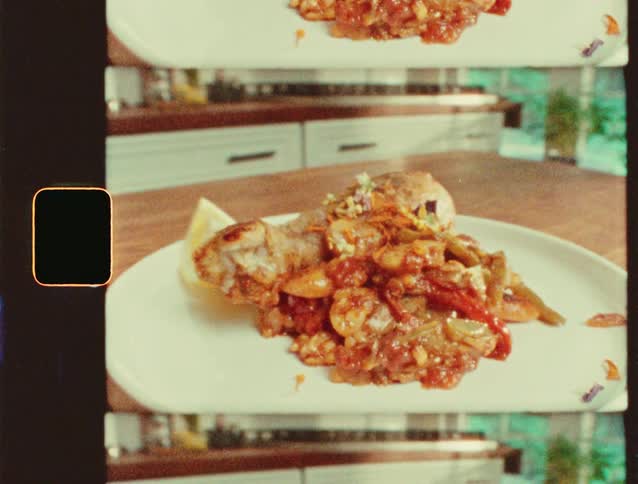 A plated dish of cooked food is captured in a vintage film frame