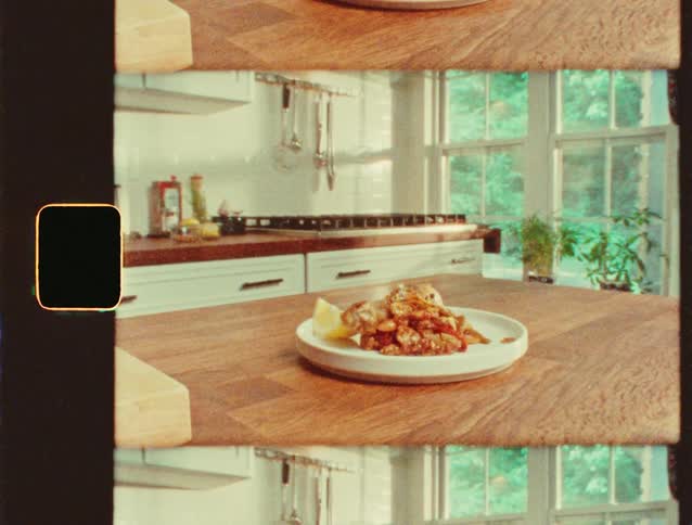 A plate of food rests on a wooden counter