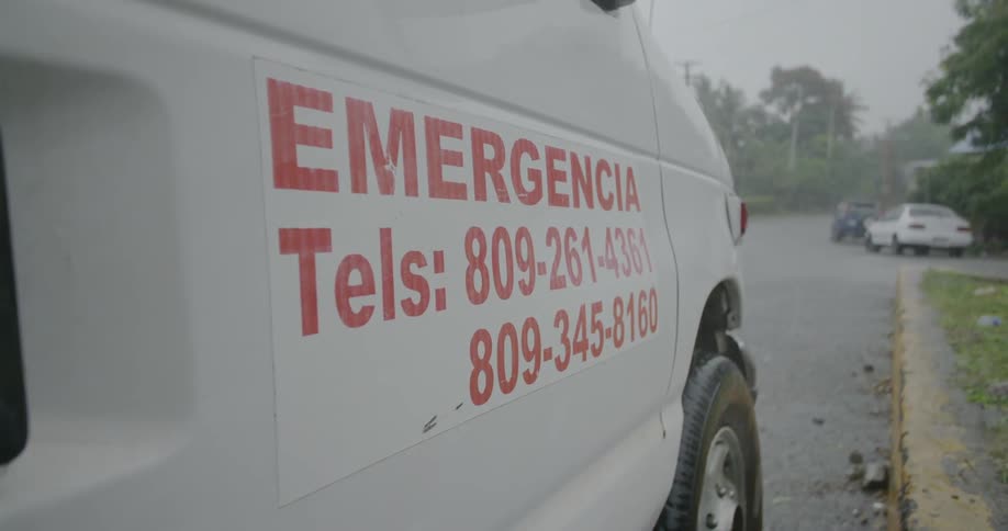 An emergency sign is attached to the side of a van
