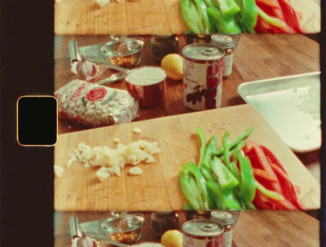 Chopped vegetables and a knife sit on a cutting board