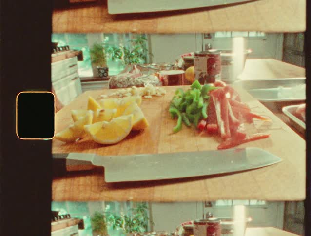Sliced vegetables and lemon wedges in a kitchen setting