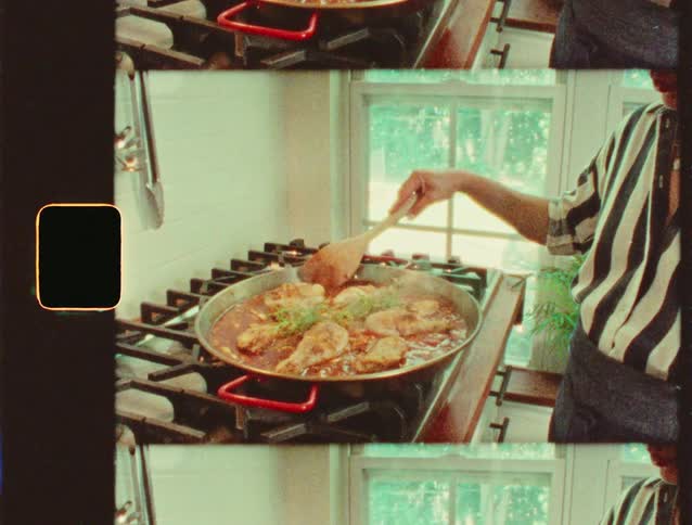 Person stirring a paella pan on the stove