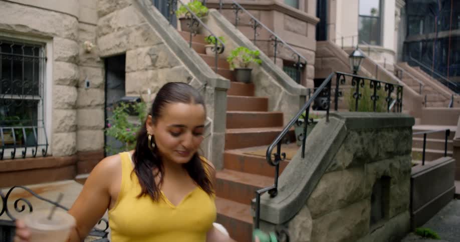 Woman walking dogs and drinking coffee from a disposable cup