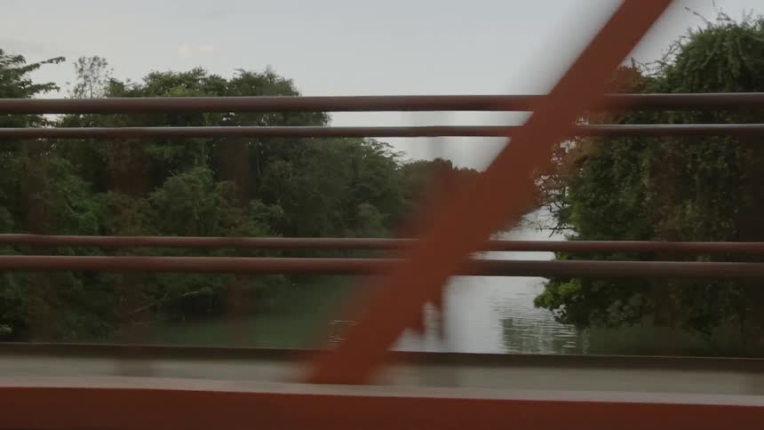 A vehicle crosses a river bridge