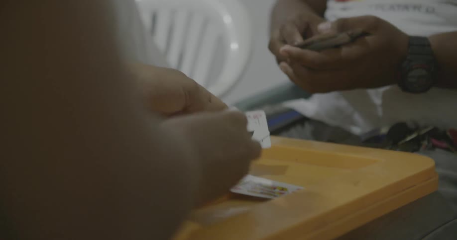 Two people play cards at a table