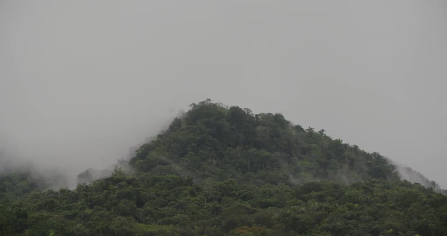 Fog lifts from the top of a mountain