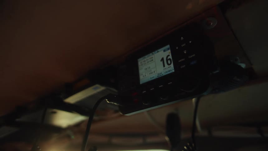 Marine communication radio installed in a cabin displays channel 16 on the screen
