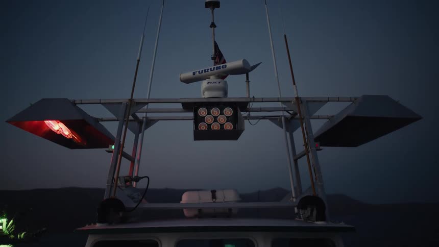 The lights flash on the fishing boat