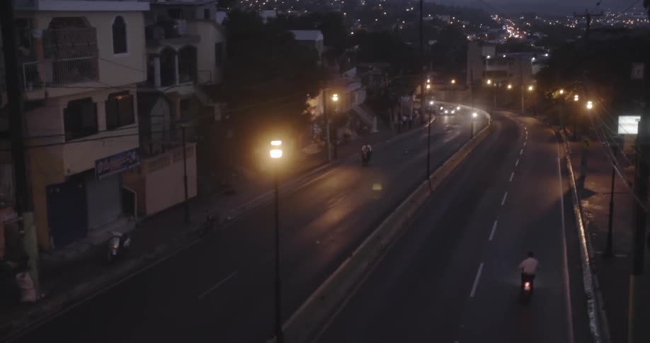 Man riding motorcycle on city highway at night