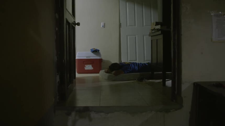 The hall leads to a cooler and door