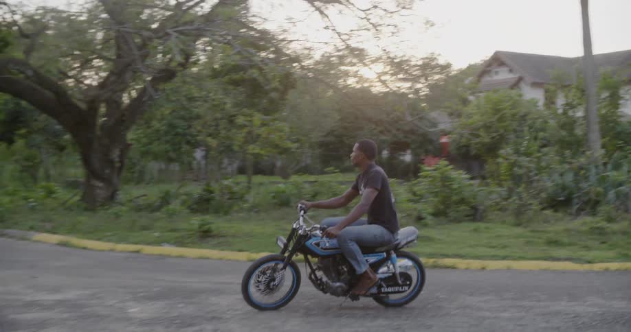A man pops a wheelie on a motorcycle