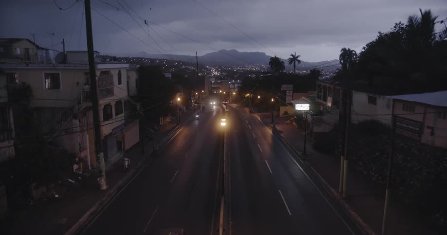 Cars drive on a city street at night