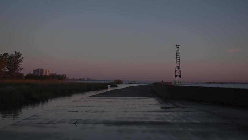 A narrow coastal pathway by the water at dusk