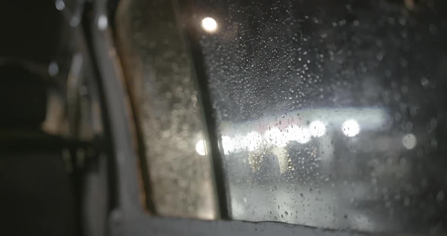 Water is on the window of the moving vehicle