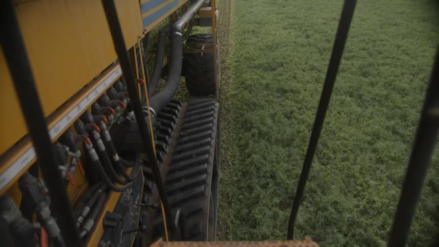The large farm vehicle is working the field