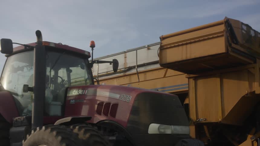 The farm vehicles are working the field