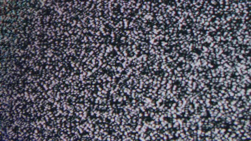Television screen displays black and white static noise