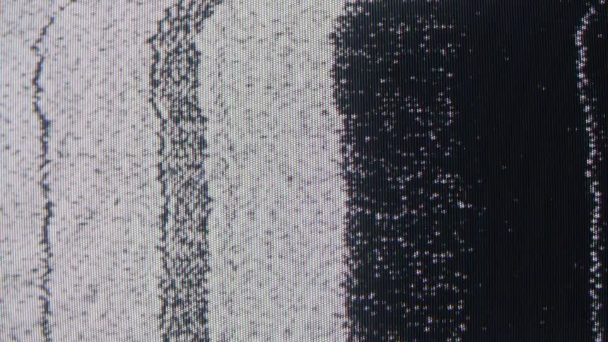 Screen with interference shows vertical black and white bands with static dots