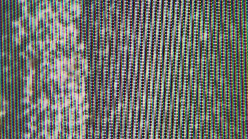 Closeup of screen pixels showing a colorful pattern with static noise
