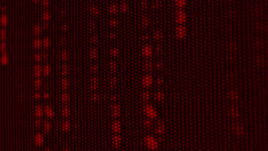 Closeup of screen pixels displaying a vivid red illuminated pattern