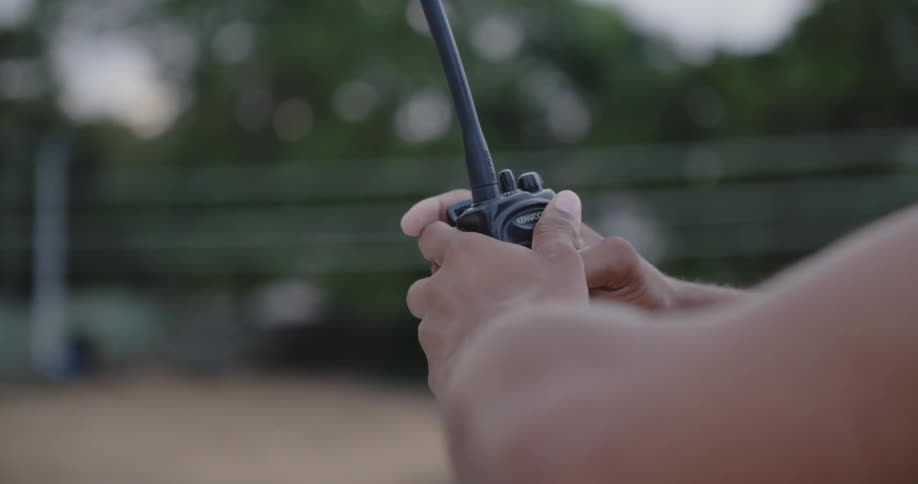 A man is holding a walkie talkie