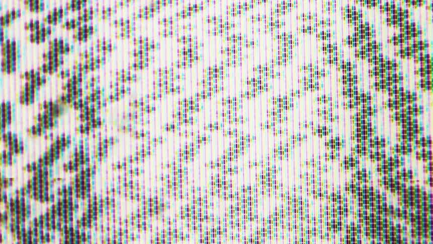 Closeup of screen pixels showing static with colorful patterns and bright areas