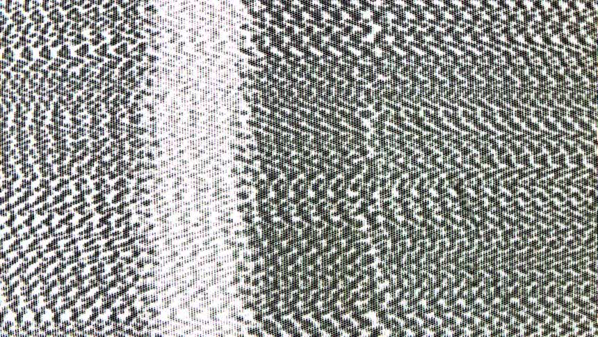A television screen displays white noise and a distorted image