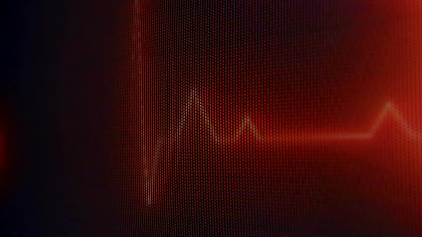 Red electrocardiogram line appears on a digital monitor