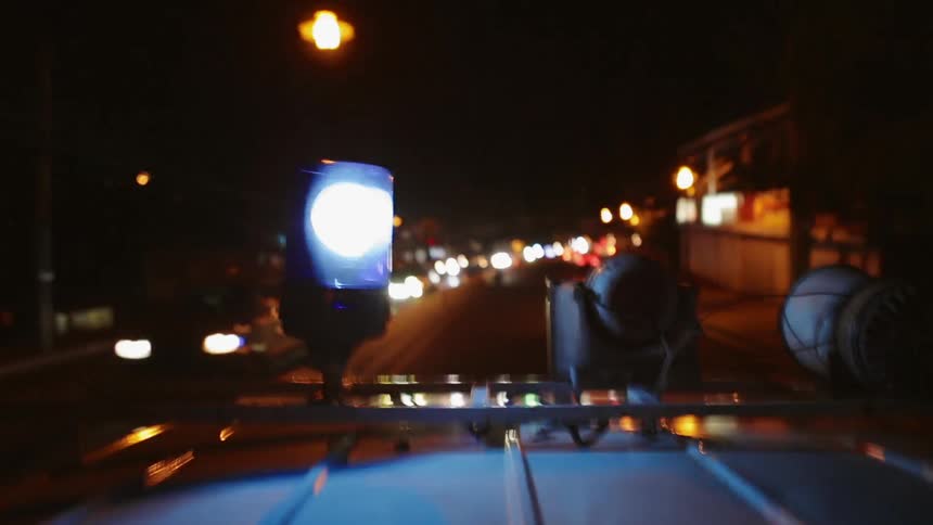 An Ambulance Speeds down the Road at Night
