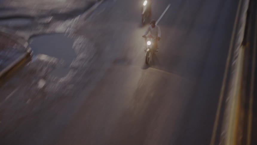 People riding motorcycles on highway at night