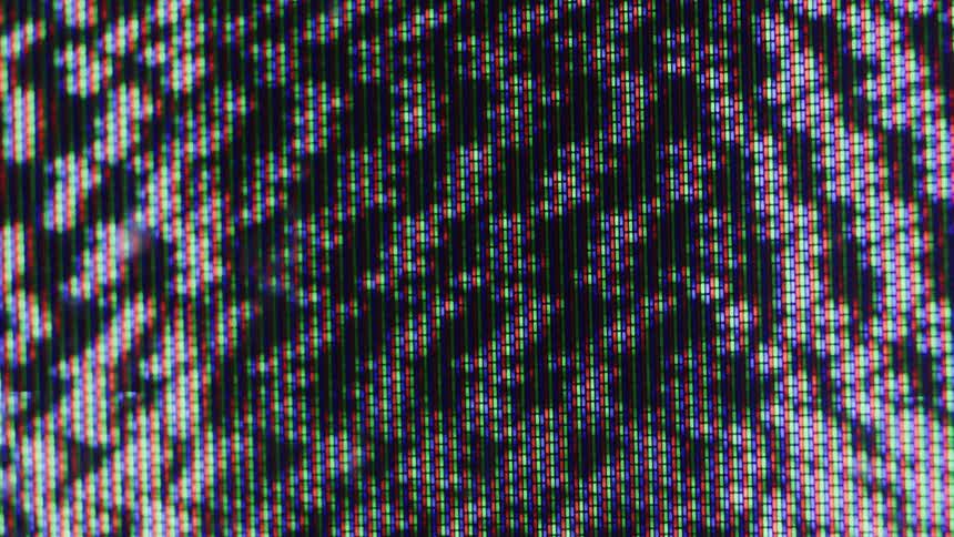 A video shows an extreme closeup of a digital screen filled with an abstract pattern the individual pixels are visible as small lights of different colors