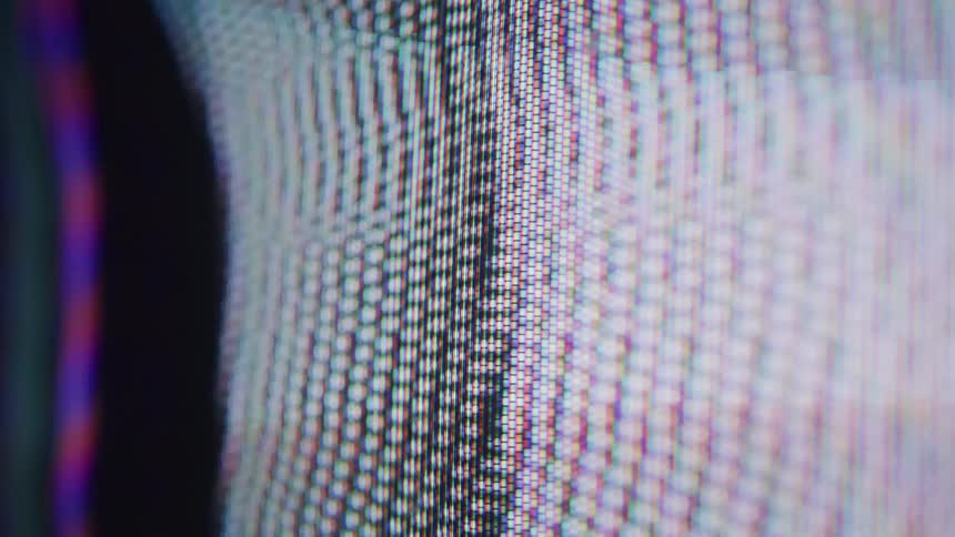 A video shows a very closeup shot of a screen with a gridlike pattern the pixels are visible in a structured arrangement
