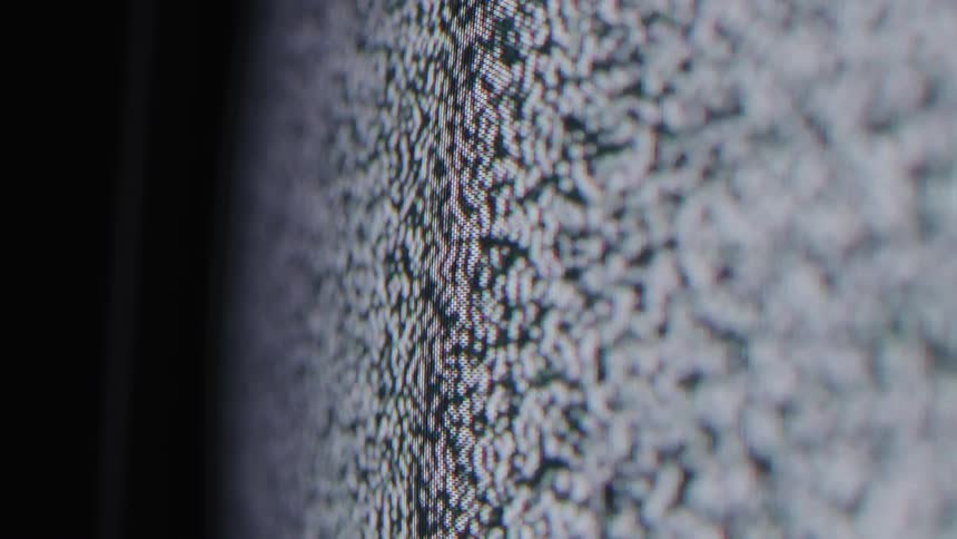 Closeup of a tv screen showing analog static noise