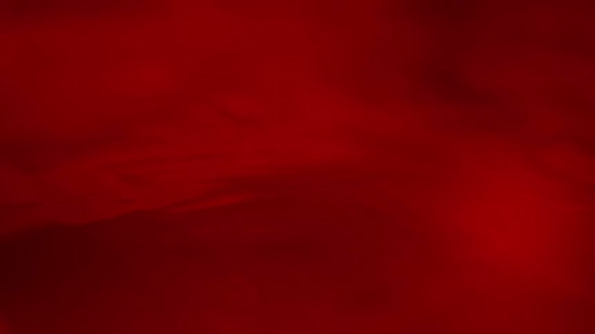 Abstract surface illuminated by intense shades of red