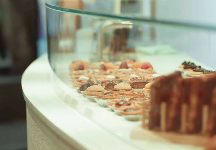 The display on the counter of the restaurant is full of deserts