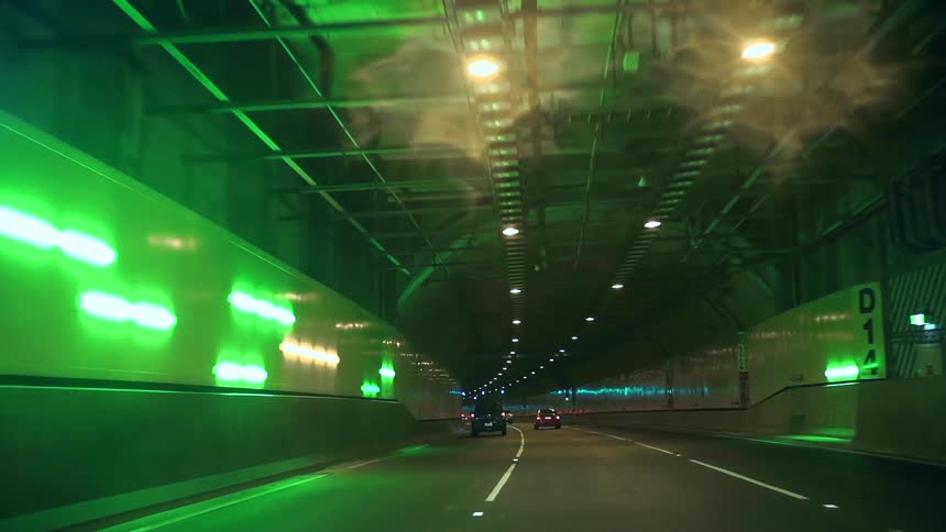 Cars traveling in a lit tunnel