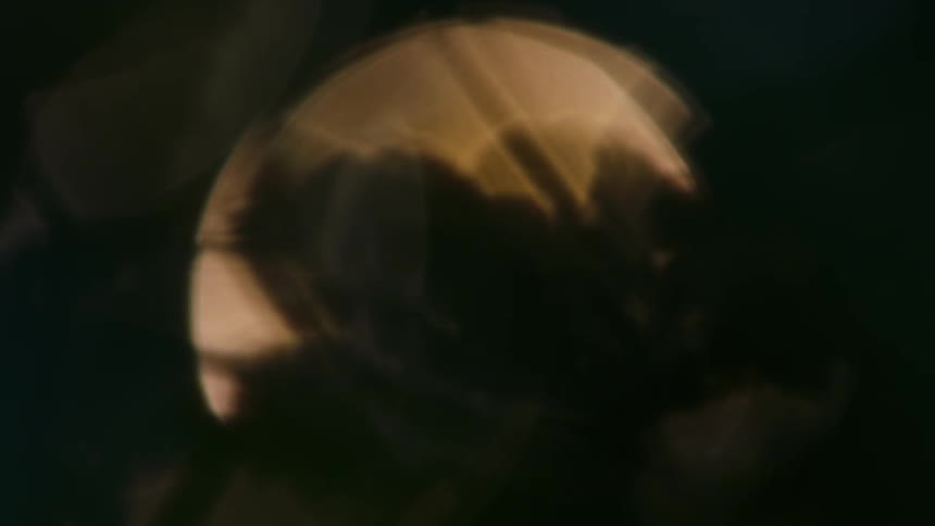 Blurred reflection of circular light in golden tones