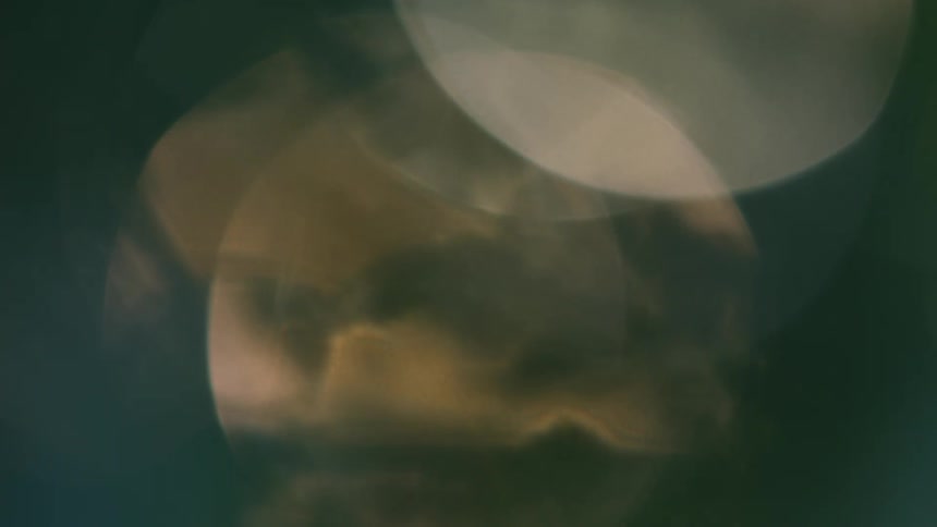 Abstract circles of golden and green light create a dreamy outoffocus effect