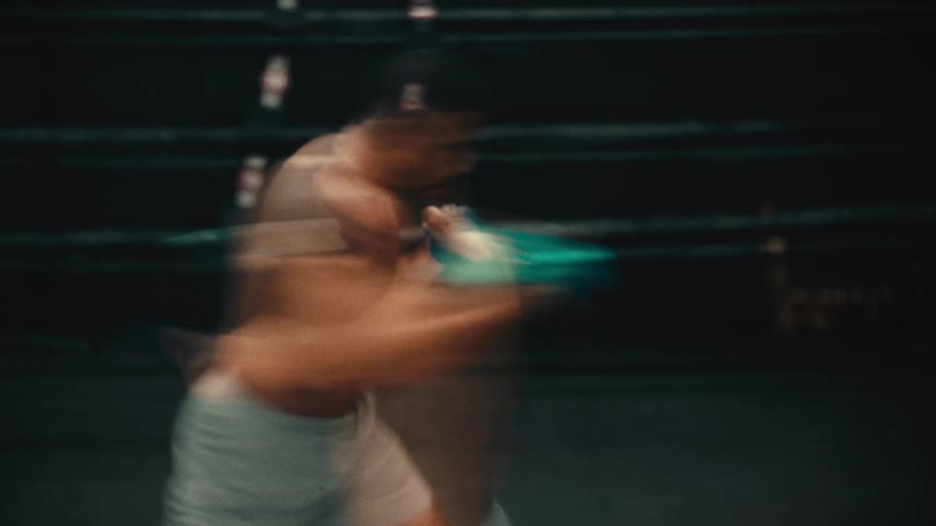 Man with boxing gloves throwing punches in a ring