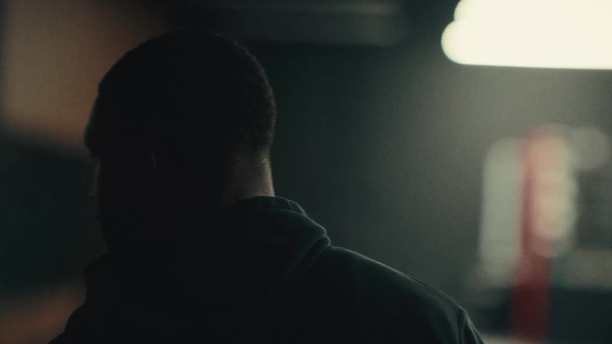 Man in an indoor space at night