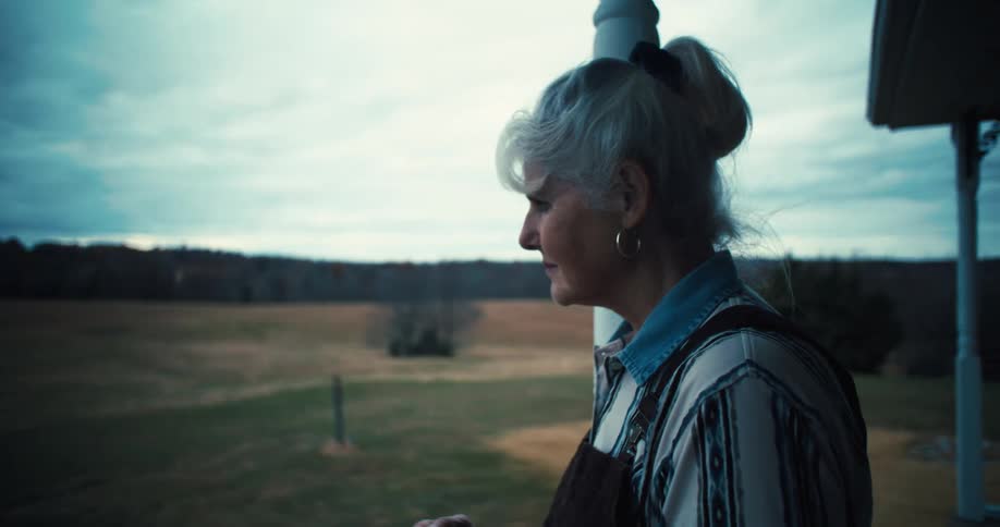 Elderly woman on a porch with a coffee mug
