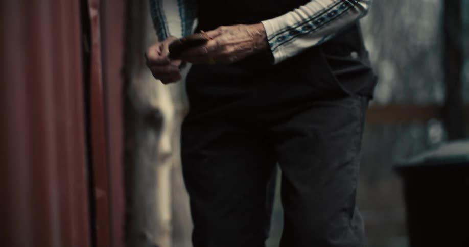 The video begins with a closeup on a persons hands and legs as they manipulate an object with their hands it then cuts to a shot of a woman with white hair pulled back in a high ponytail who is smiling while wearing striped longsleeved shirt and dar