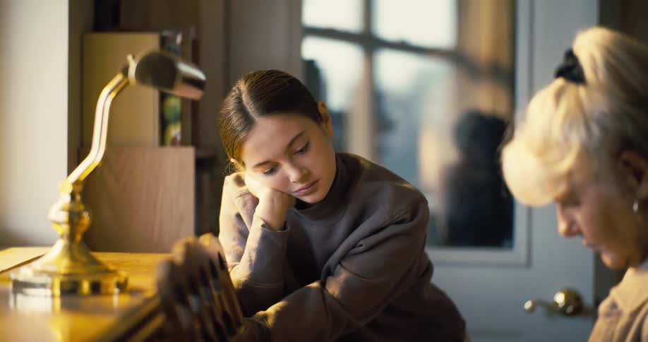 Girl accompanying an elderly lady playing the piano