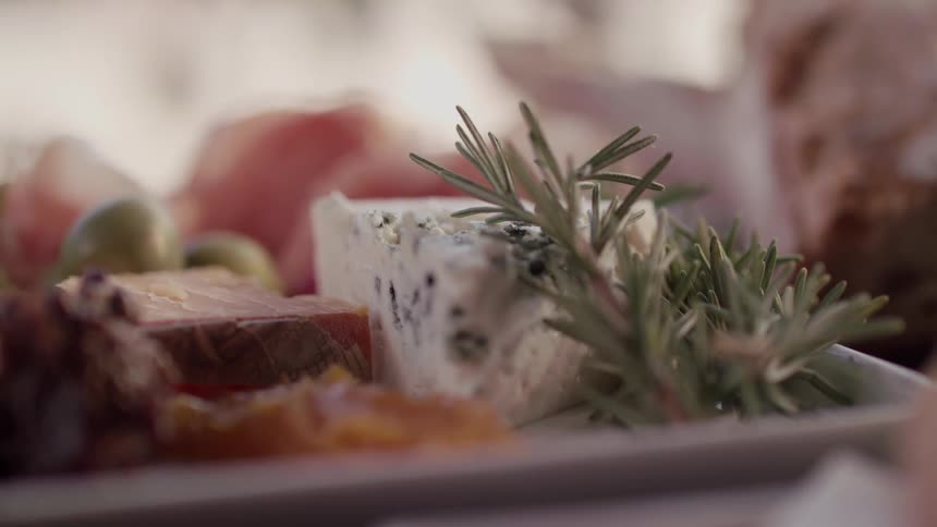 Cheese and fruit are served on a plate