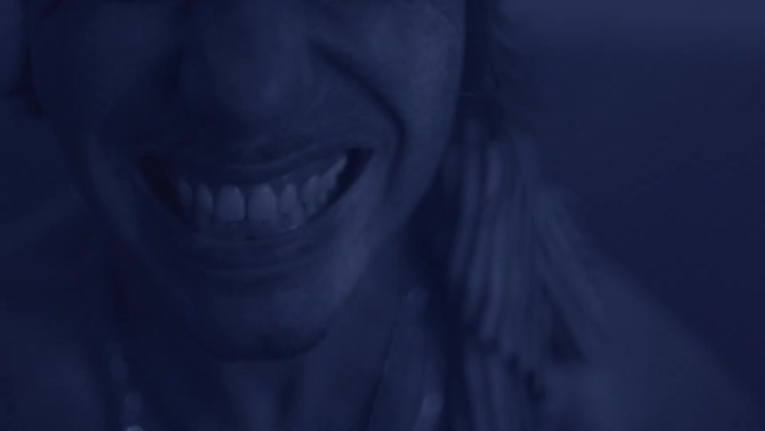 Person screaming under dark blue lighting