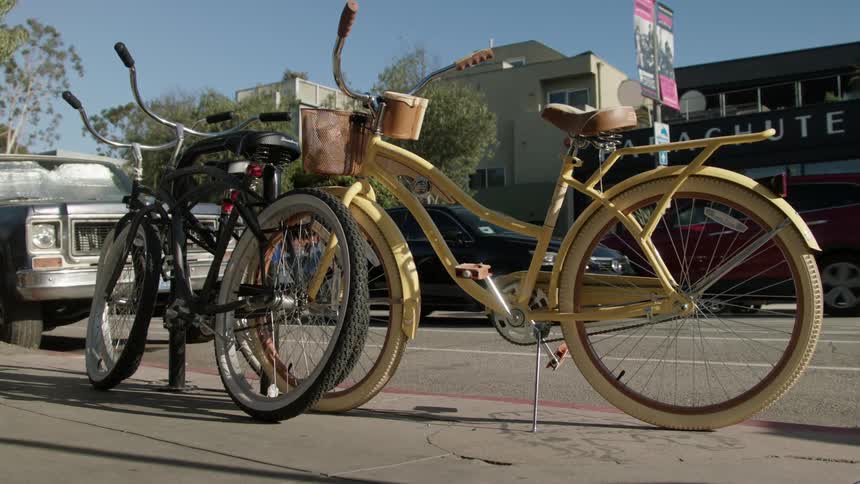 A man walks past some parked bicycles