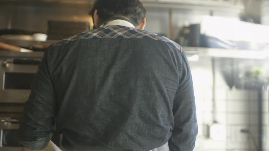 A man works in a commercial kitchen