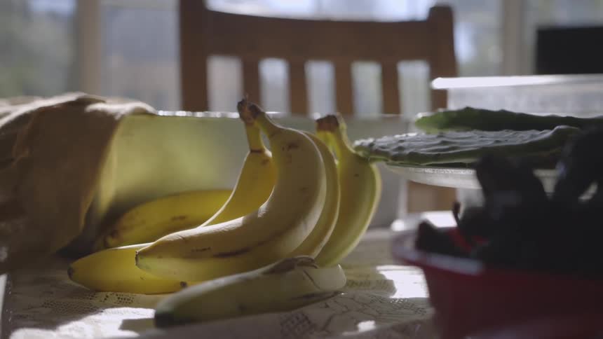 A bunch of yellow bananas are on a table