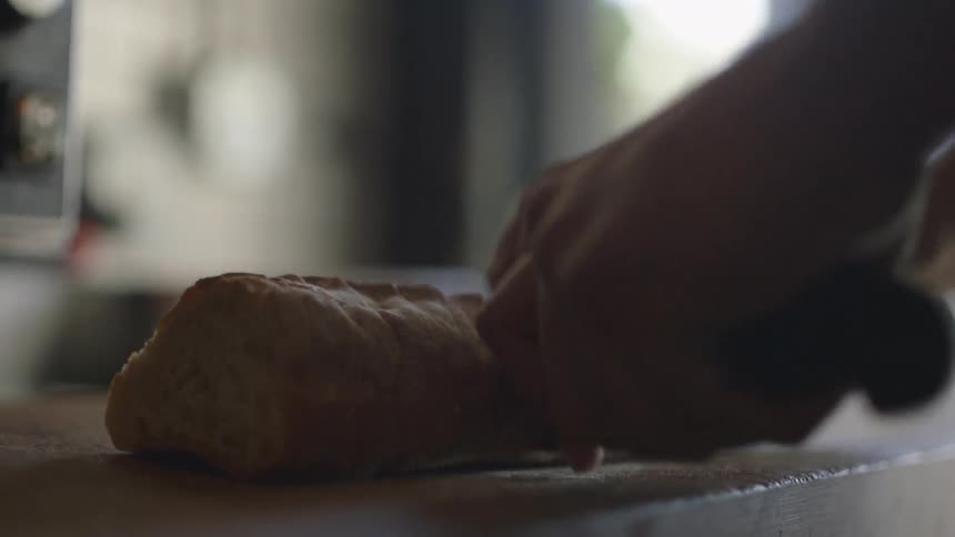 A person slices bread